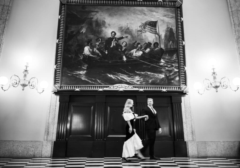 black and white editorial photo of couple in Ohio Statehouse Rotunda showcasing artwork