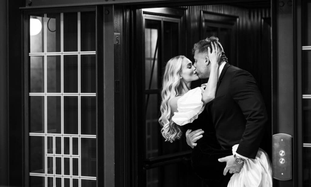 Engaged couple kissing in elevator in The Ohio Statehouse