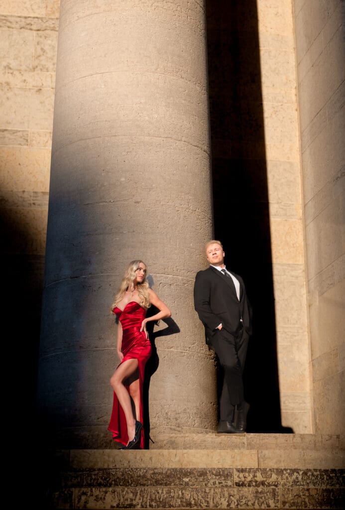 Outside The Ohio Statehouse bride and groom pose in dramatic lighting on column
