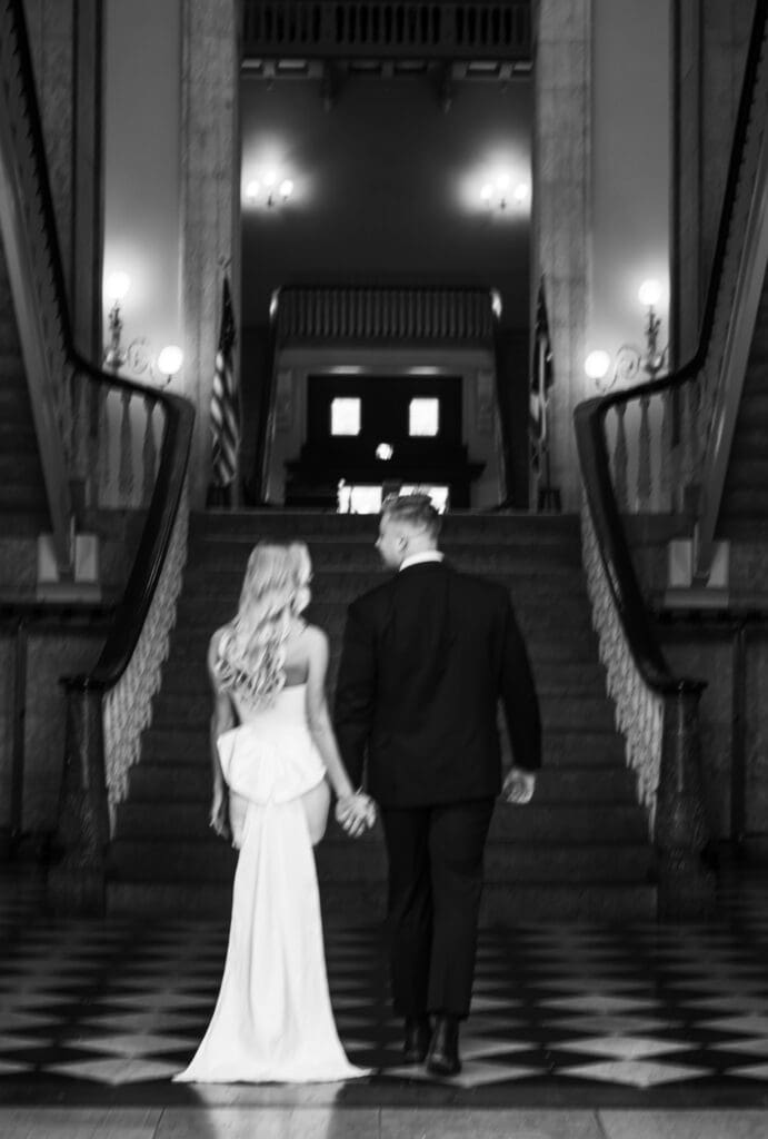 black and white blurry walking photo at the Ohio Statehouse showcasing brides dramatic back bow
