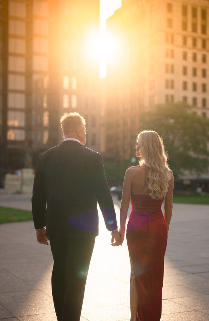Couple holding hands in downtown Columbus during golden hour
