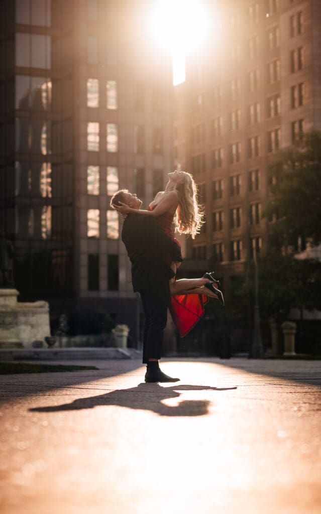 groom twirling bride during golden hour in downtown columbus