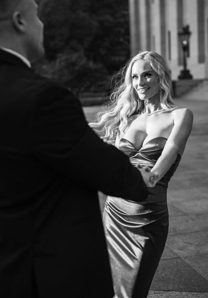 Black and white candid photo during engagement session outside The Ohio Statehouse