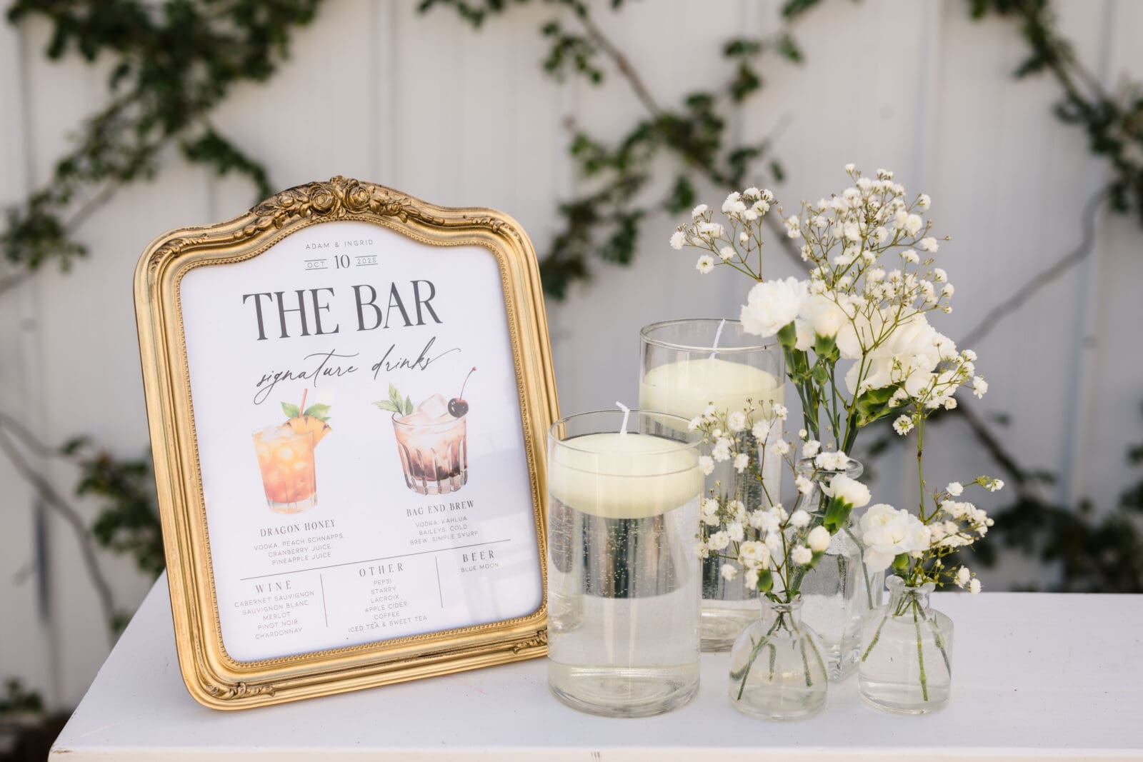 Romantic wedding design and floral details at Aspen & Alston garden party wedding custom drink sign at outside bar