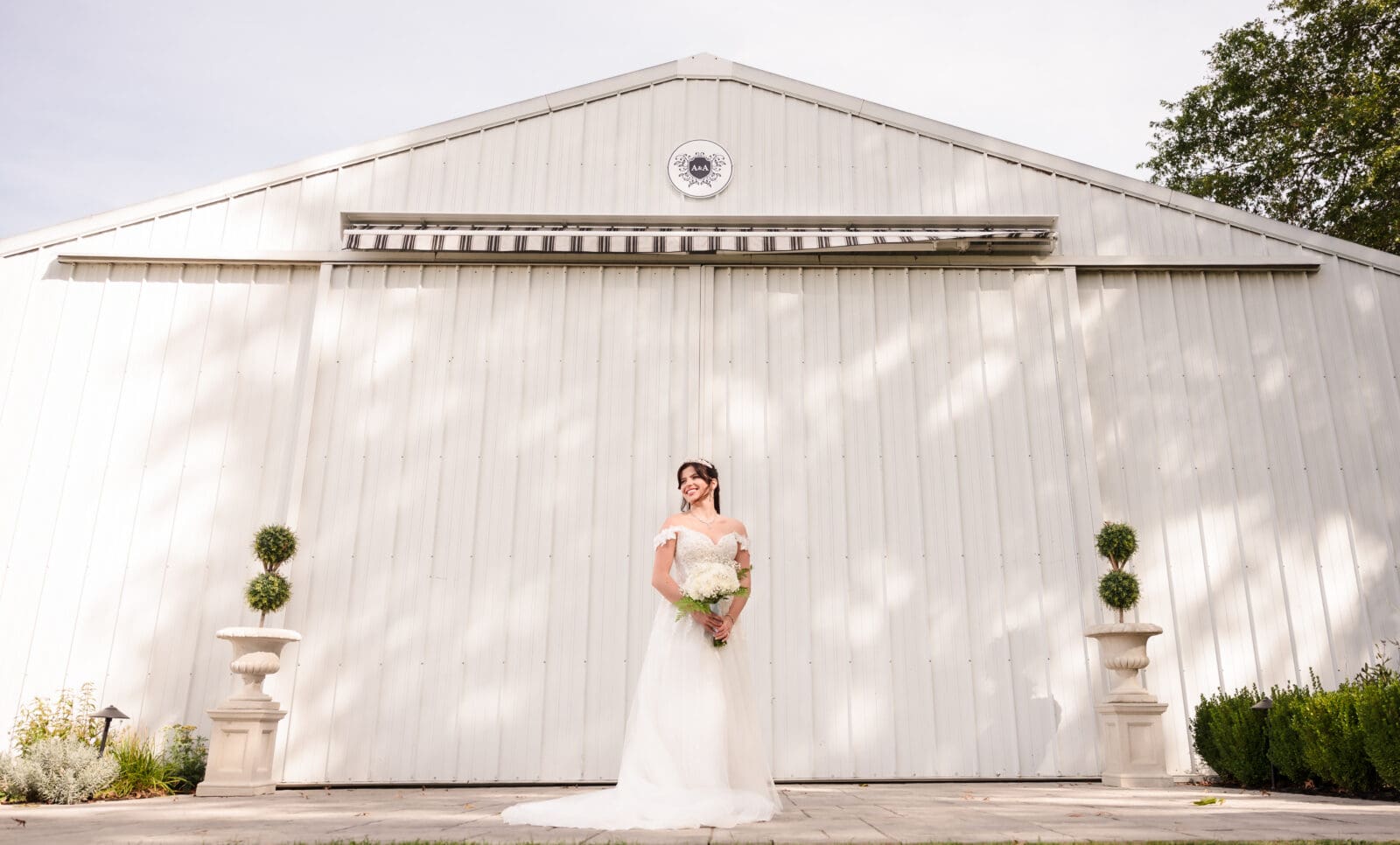 Aspen & Alston garden party wedding with romantic moment of wide bridal portrait outside of venue