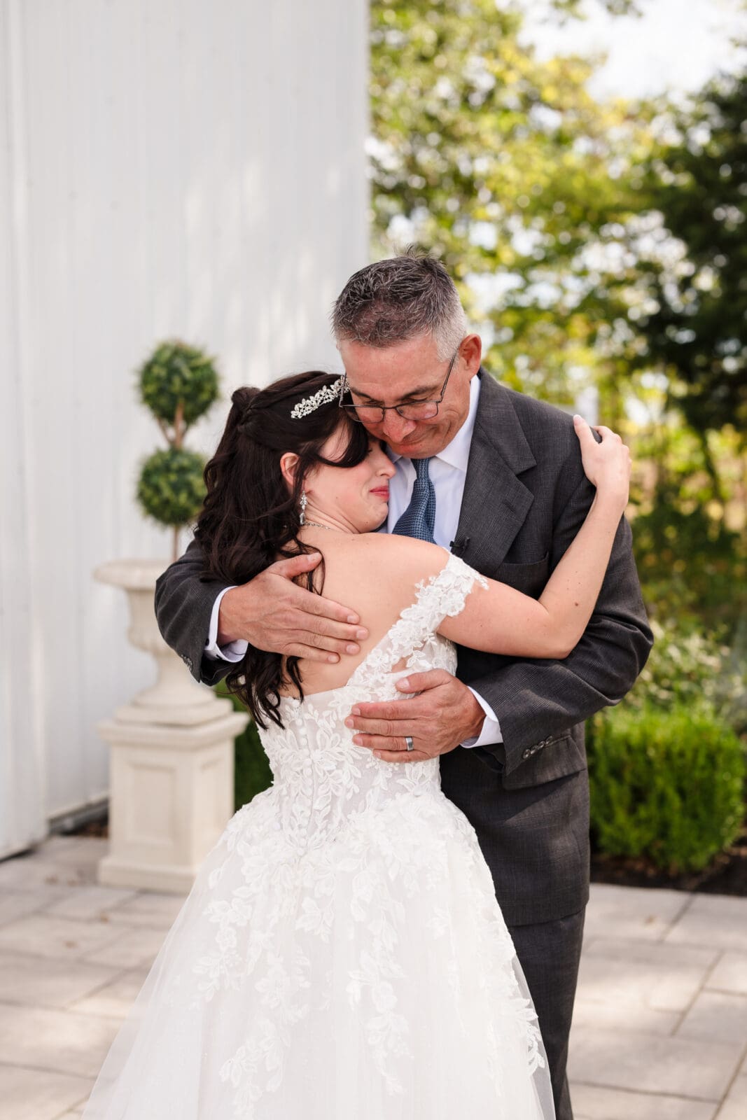 Intimate and emotional Aspen & Alston wedding capturing real connection of hug between father and daughter after their first look 