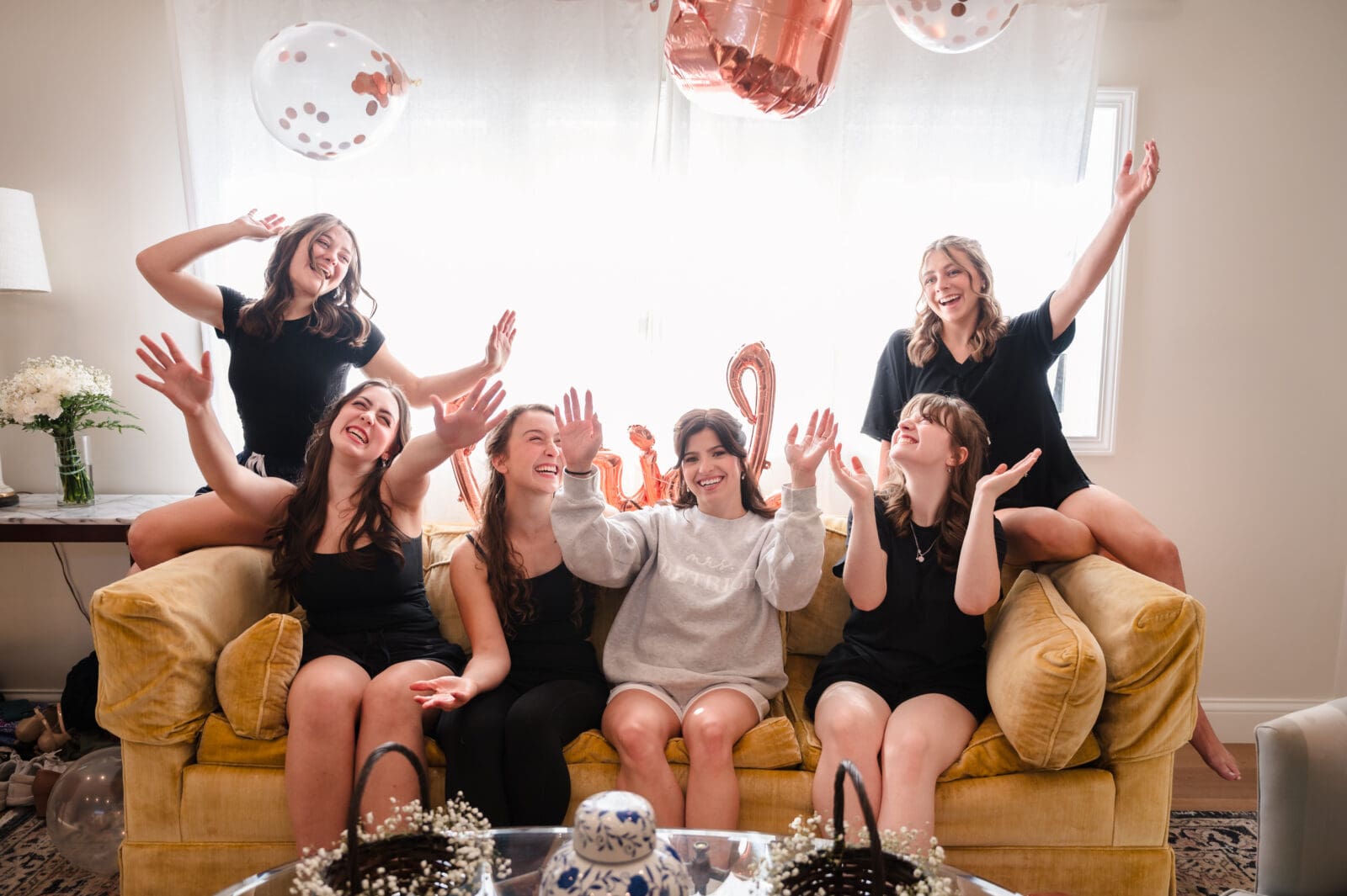 bride and bridesmaids laughing and throwing balloons at Aspen and Alston on wedding day