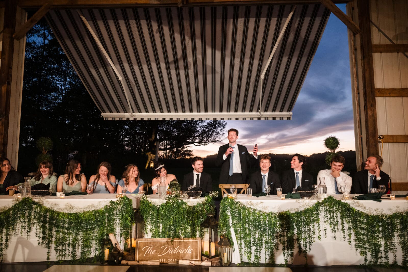 Heartfelt wedding moments at Aspen & Alston during romantic garden party reception with brother giving speech and guests laughing