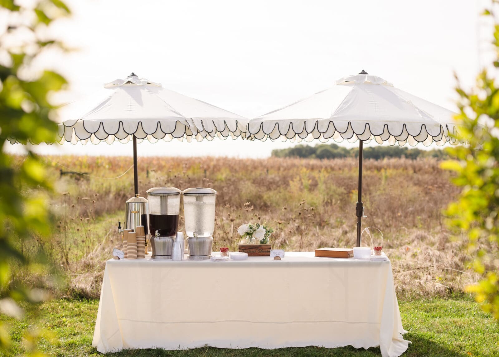 Aspen & Alston wedding venue styled with refined and elegant garden party decor cocktail hour drink table with detailed umbrellas
