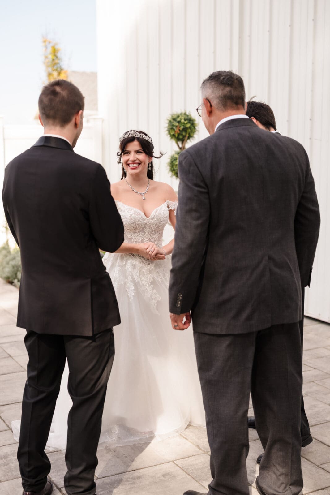 Emotional garden party wedding at Aspen & Alston with meaningful candid moments like this exchange between family during first look