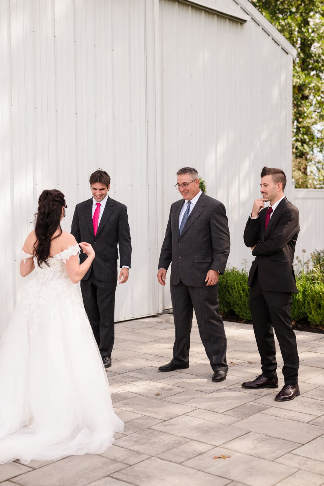 Emotional garden party wedding at Aspen & Alston with meaningful candid moments during first look with dad and brothers