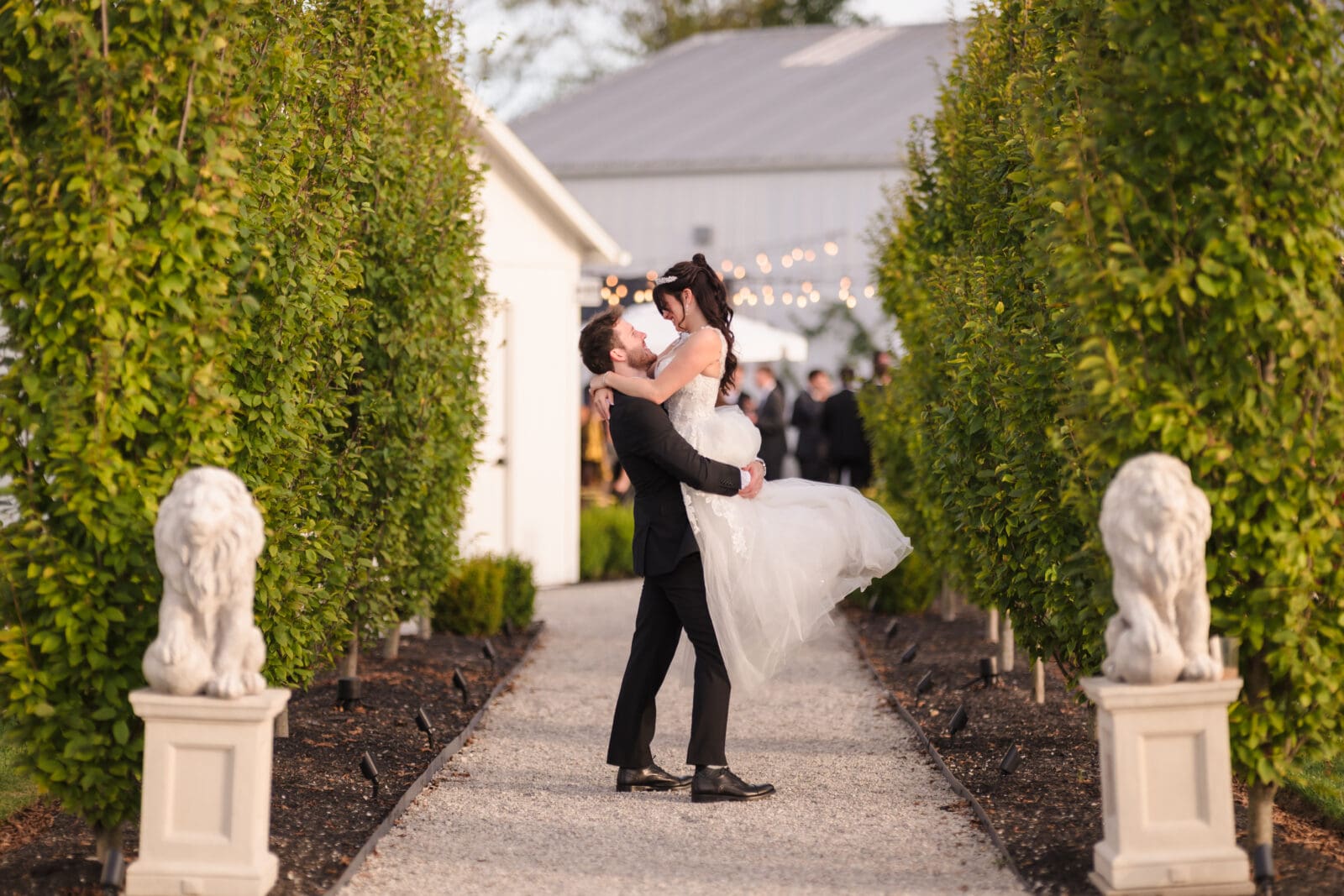 groom lifting bride at outdoor garden area of Aspen & Alston wedding day