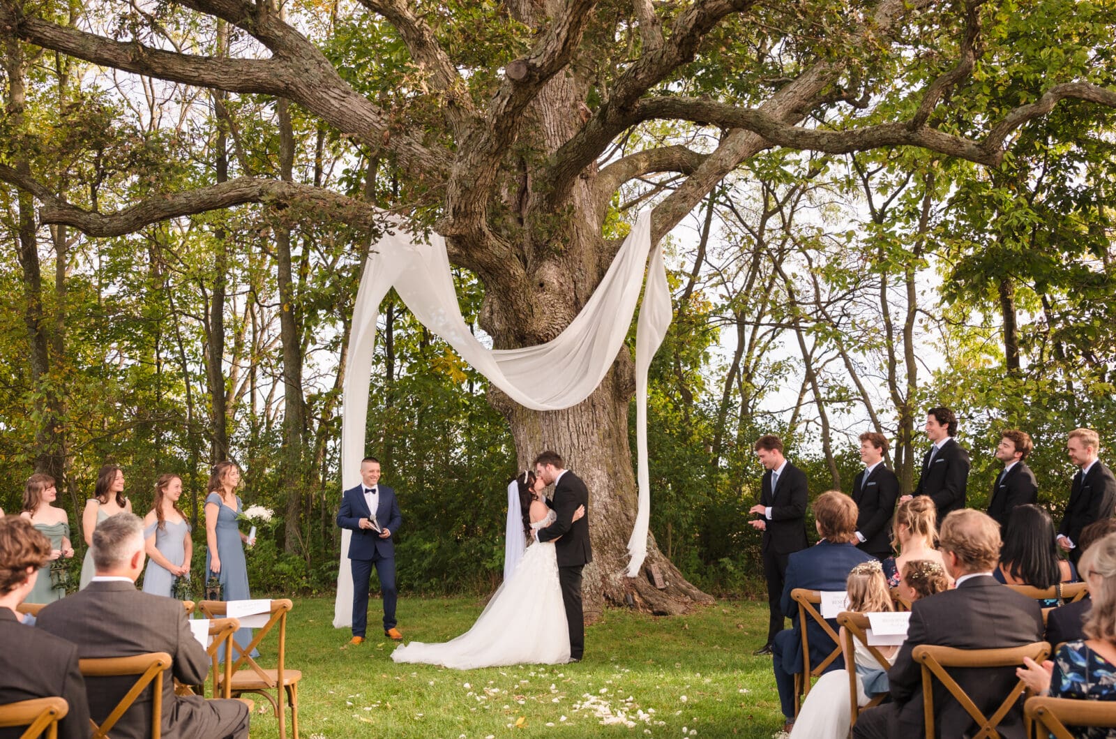 Emotional garden party wedding at Aspen & Alston with meaningful candid moments like this first kiss