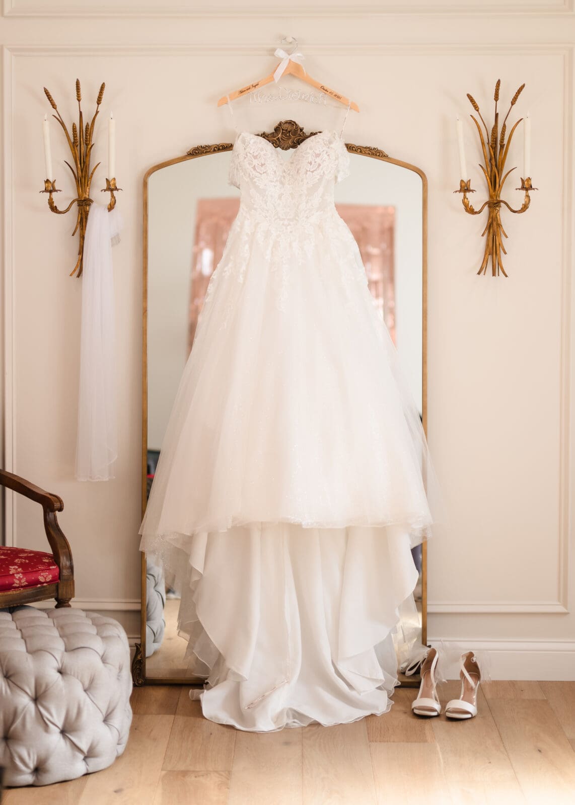 Brides gown hanging in front of mirror at Aspen & Alston wedding