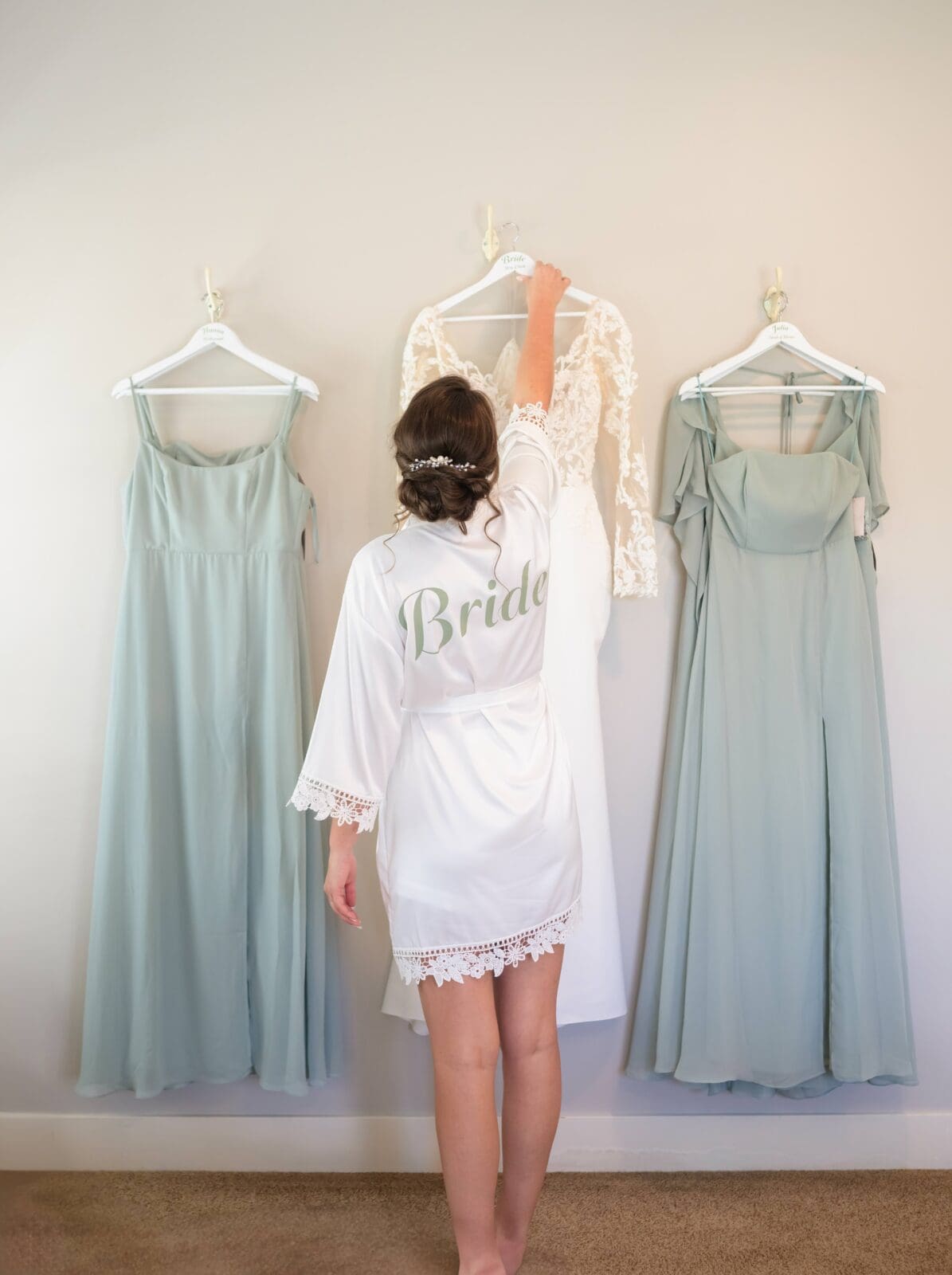 bride hanging wedding dress at Flora and Field bridal suite after thoughtfully wedding dress shopping