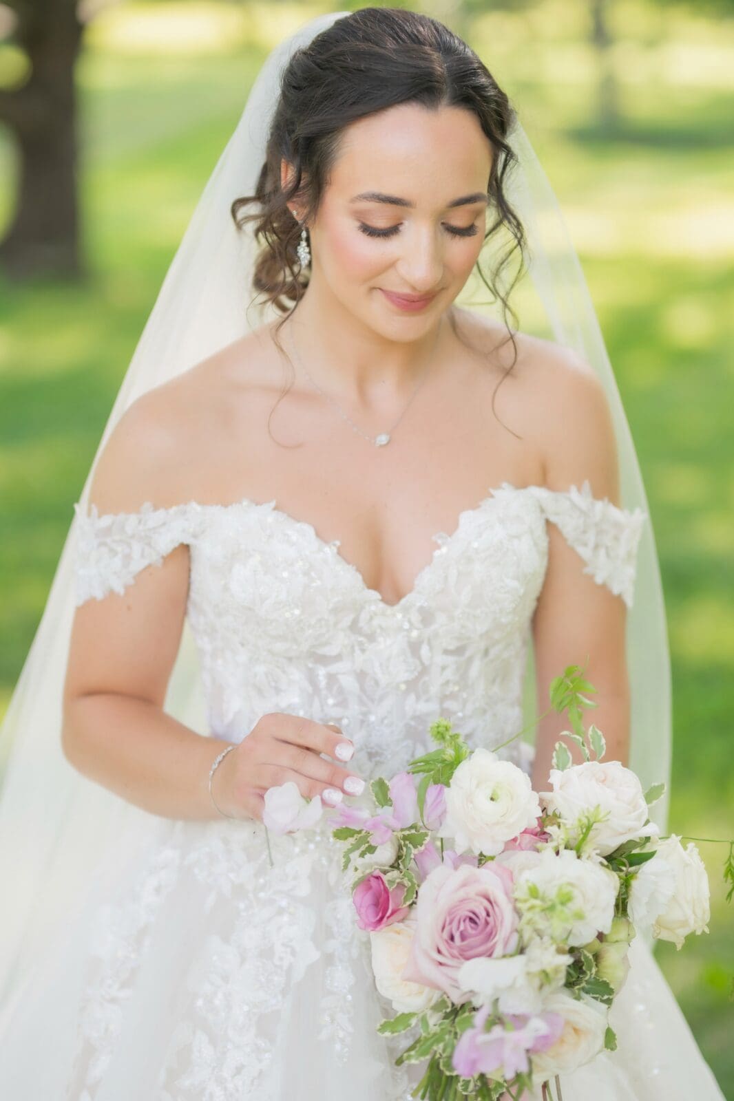 after wedding dress shopping for the perfect dress bride is posing on wedding day at Darby Creek with her bouquet