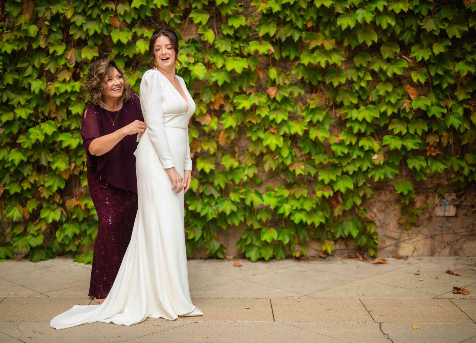 mother of the bride helps bride with her wedding dress morning of the wedding Columbus Ohio