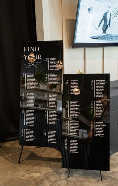 Custom black seating signs placed at entrance into reception space at Retreat 21