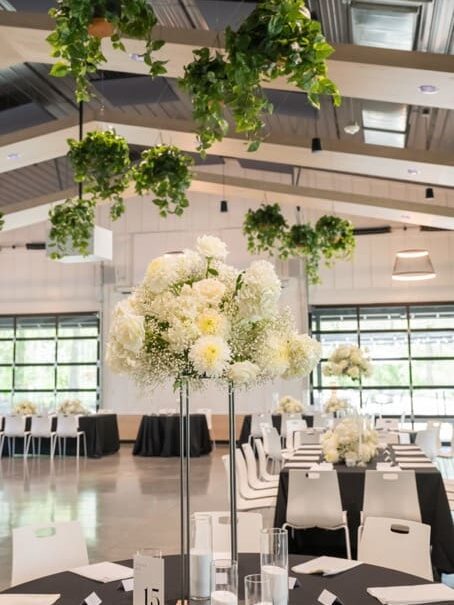 Flowers on table at reception space in Retreat 21 wedding venue