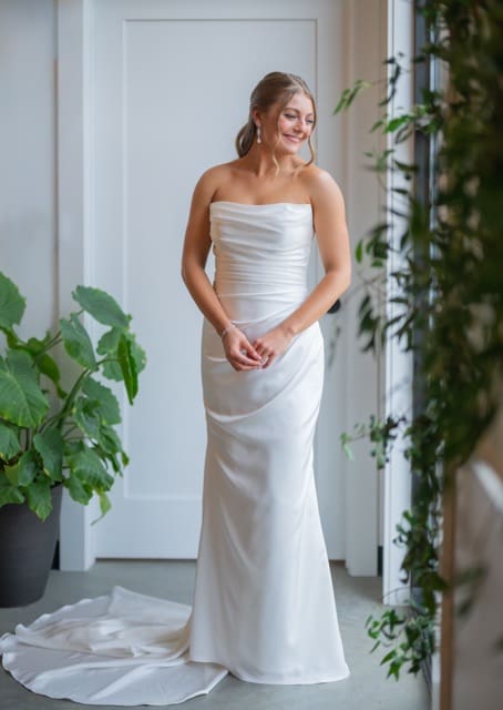 Bride posing by window at Retreat 21 wedding photography