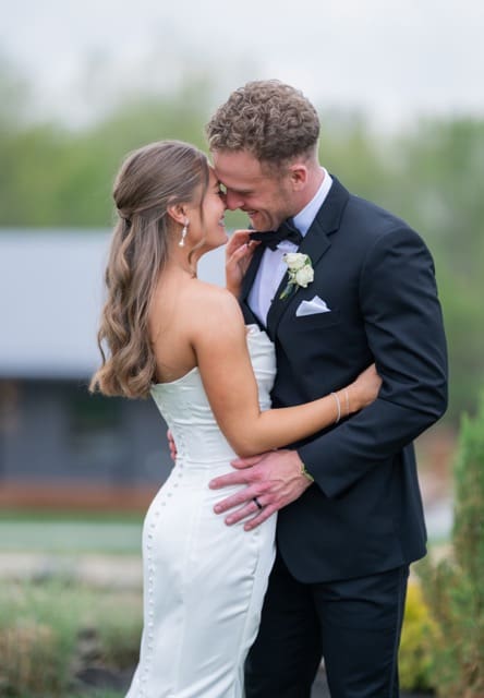 Bride and groom embracing and smiling together outside at Retreat 21 