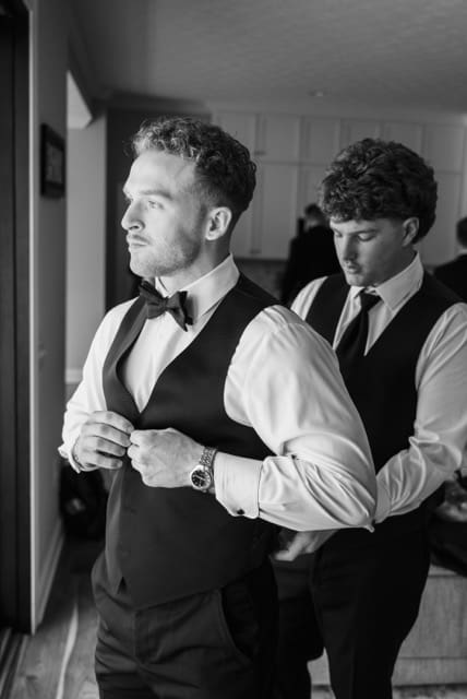 Groom getting dressed on his wedding day at Retreat 21