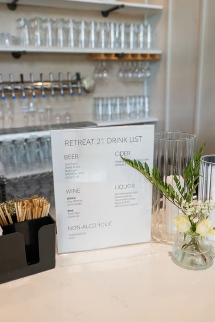 Bar signs of drink list with bar in background at Retreat 21