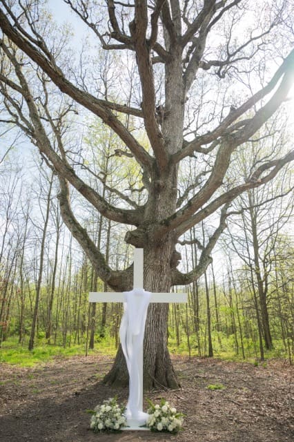 Wooden cross made by the bride's father as a backdrop to their wedding ceremony at Retreat 21