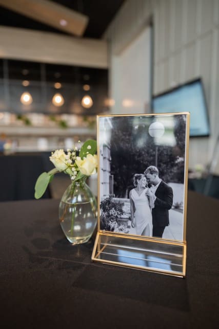 Engagement photo framed as wedding decor on cocktail table at Retreat 21