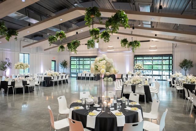 Black and white wedding day decor of reception space at indoor Retreat 21