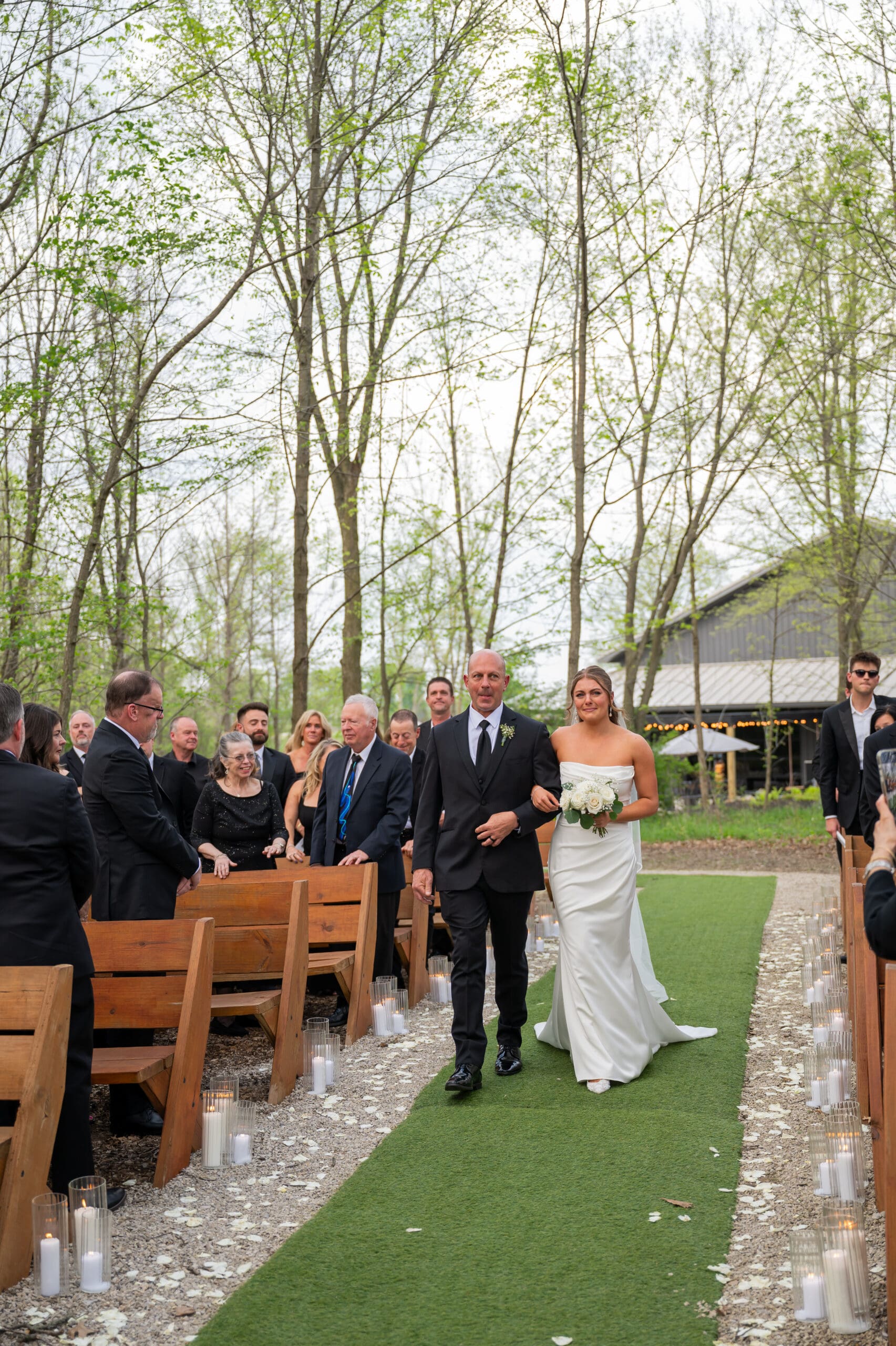 Father of the bride walking bride down the aisle at outdoor ceremony space of Retreat 21