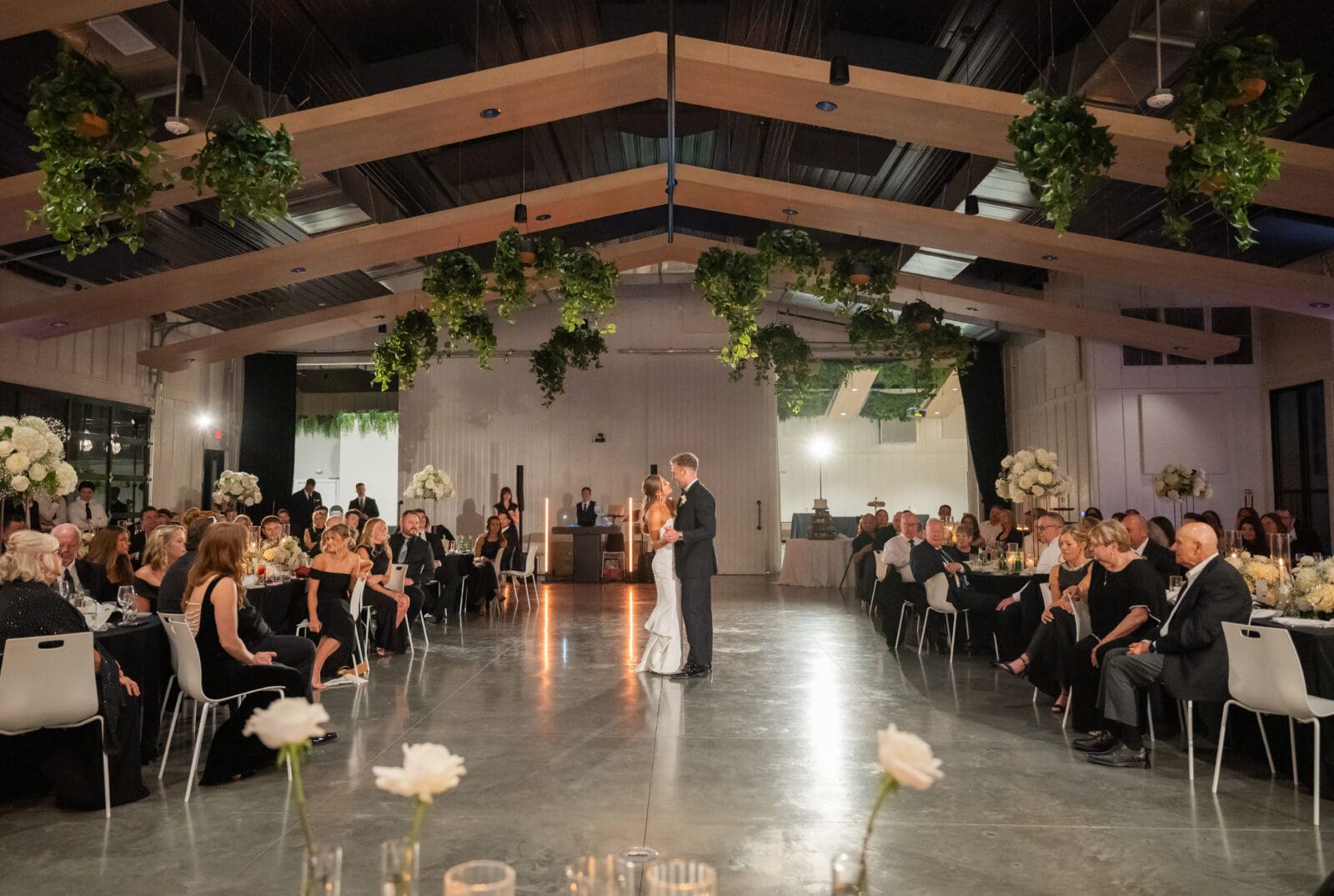 Couple sharing emotional first dance as everyone watches at Retreat 21